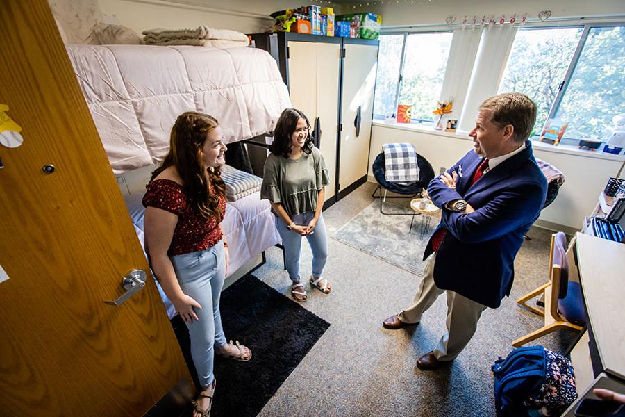 President Tatum conversed with first-year early childhood education majors Briana Crites and McKenna Black after they won a residence hall room-decorating contest in October. (Photo by Todd Weddle/Northwest Missouri State University)